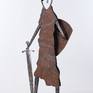 The steel sculpture "Knight on Guard" loosely follows my previous silhouette and figural stylizations. However, the overall tone is different both in the form of stylization of the body and the focus on the small details that are decisive for the artwork and which are characteristic of the image of a knight.
The theme itself, the figure of a knight on guard, is not an image of a warrior, but a knight for whom honor and pride were something for which he was willing to die. The theme is the guardian of honor, loyalty and honesty.
An old rusted sheet metal is used on the body, which is partially embossed so that the surface sculpture is completed by shadows. The other parts are forged.
The sculpture is signed on the base.
