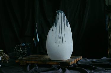 White vessel with black drips thumb