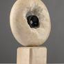 The ring itself is a symbol of community and alliance. Indicates a cycle that is indeterminate and uninterrupted. The flow of time. In the sculpture, he represents the artist's vision of the soul: infinite, but seemingly empty. The smaller ring represents all our dreams, longings and faith using which we fill that void.