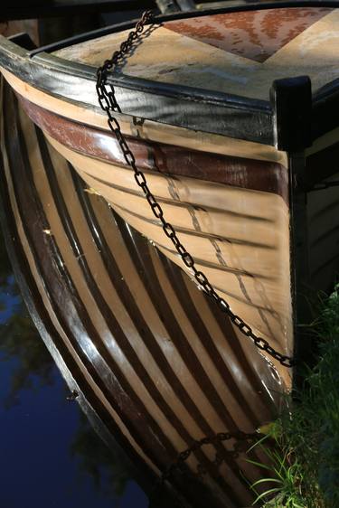 calm lake with anchored rowing boat thumb