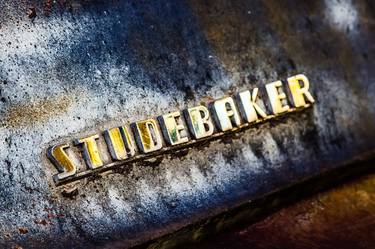STUDEBAKER sign on an old, rusty and wet truck thumb