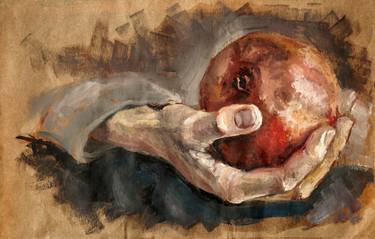 Hand holding a pomegranate thumb