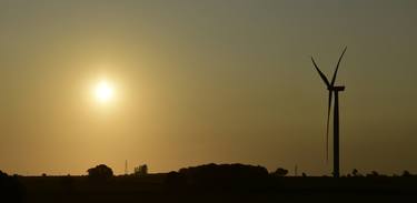 Wind turbine at sunrise. thumb