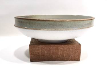 White and celadon green glazed bowl with iron oxide thumb