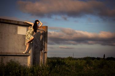 Girl on the fence in the field thumb