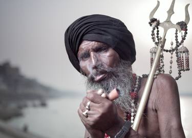 Portrait of Sadhu Aghori Baba smoking his chillum. thumb