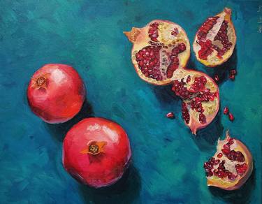 Pomegranates slices and seeds on blue background thumb