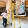 Artist standing with unstretched piece
