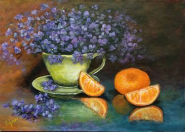 A bouquet of violets in a cup, a pleasant evening with tangerines. thumb