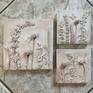 A display of multiple bas relief pieces.