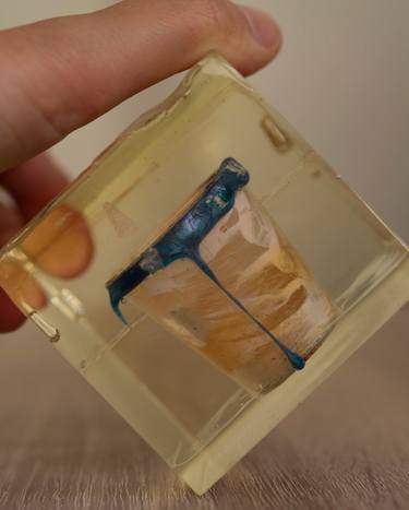 Resin cube with a plastic cup inside thumb