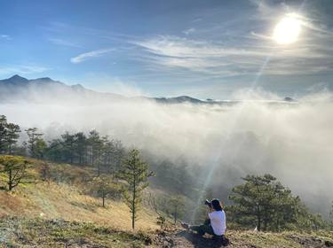 The girl hunting clouds on the hill thumb