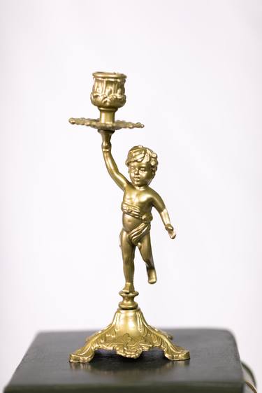 Ionic Order Column Supporting a Golden Candle Holder Ornament. thumb