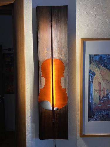 Wall sconce made from an old violin thumb
