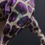 Signature of artist on the giraffe's body.