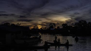 Fishermen returning at sunset thumb