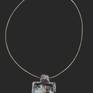 Necklace with a ceramic pendant.