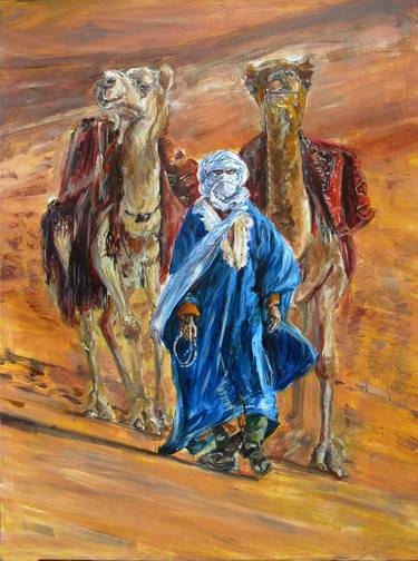 A Bedouin in festive clothes walks through the desert with camels thumb