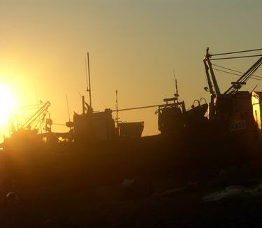 Sunsets over the Fish Industry, only chips eaten on the beach in the dark thumb
