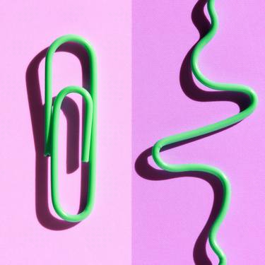 green paperclips on pink thumb