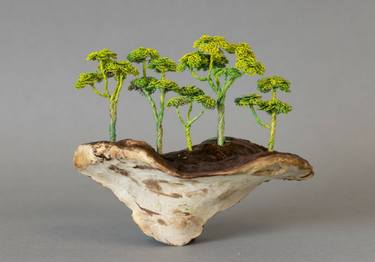 Copper wire tree placed on mushroom thumb