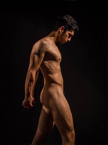 Naked man moving forward. Muscular tension in a male nude. thumb