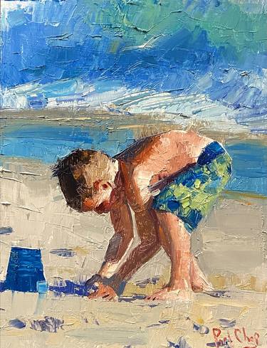 BOY PLAYING SAND IN BEACH thumb