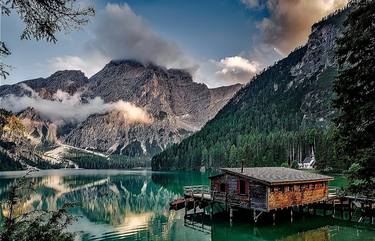mountain with a house and a lake thumb