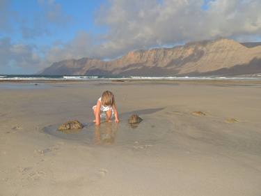 Baby girl playing at Famara Beach in Lanzarote, Canary Islands thumb