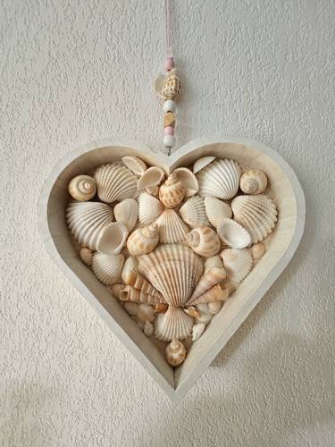 Heart made of shells in a wooden shape thumb