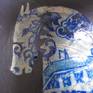I love the willow pattern and I love painting horses so I've combined the two to be like cracked, faded china that you find on the seashore. There are willow pattern bluebirds in relief in the corners.