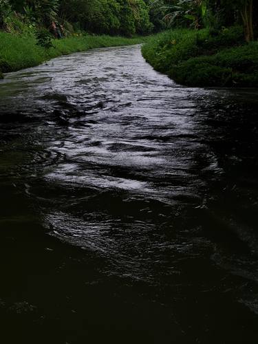 Beautiful view of a stream under a bridge. thumb