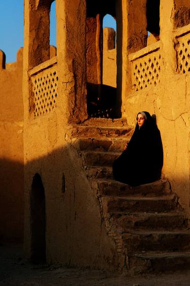 woman watching the sunset on the stairs thumb