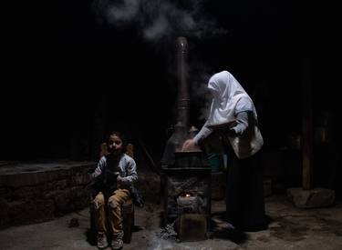 woman cooking and her daughter thumb