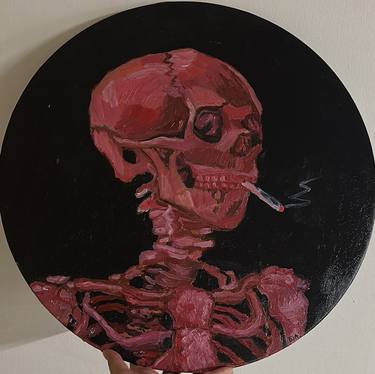 The pink head of a skeleton with a burning cigarette thumb