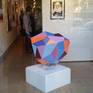 Sculpture with plastic, painted with acrylic paint. Sits on top of a glass stand (included with sculpture)