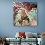 Stylish sofa with pillows under modern artwork