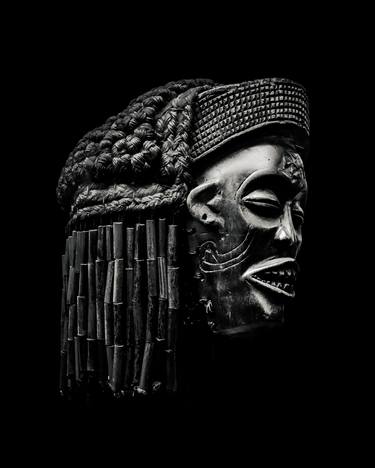 African Head Sculpture Over Black thumb