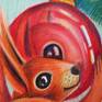 Squirrel holding red Christmas tree decoration