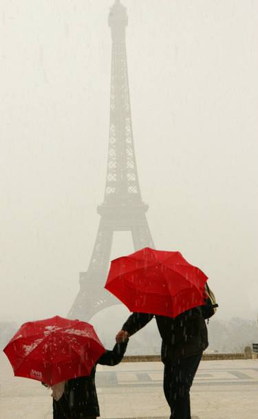 Red Umbrellas at the Eiffel Tower during a hailstorm thumb