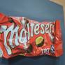 An original, one off painting of the ever recognisable Malteser bag against a dark grey background to really show its rich colour. Hand painted on MDF wood canvas coated in a layer of satin varnish that gives a crisp, detailed finish.Painted in the style of Photorealism with oil paints this piece really captures your attention with its vivid colours, depth and intense realism.