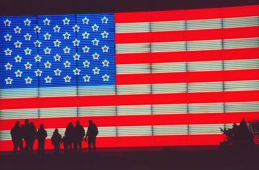Silhouetted Family and Huge Neon United States Flag thumb