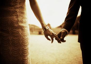 Bride and groom holding hands in sepia thumb