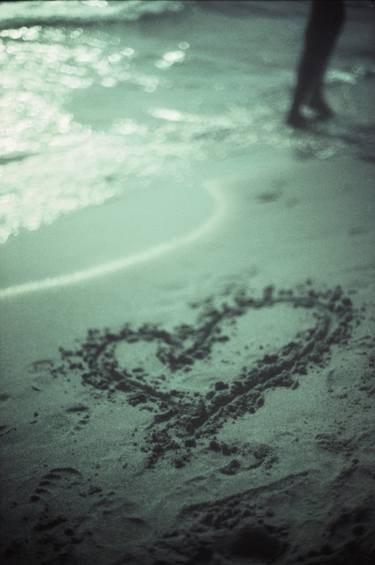 Love heart drawn on beach sand at low tide with ocean sea thumb