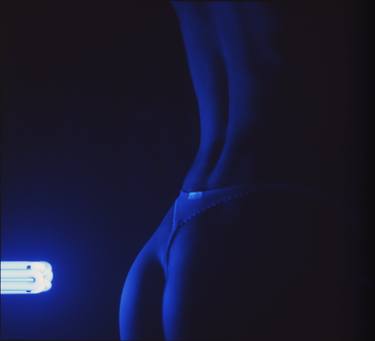 Sexy young lady nude in g-string in blue black light thumb