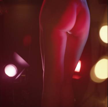 Analog photo of sexy young lady nude lit by stage lights in pink and purple thumb