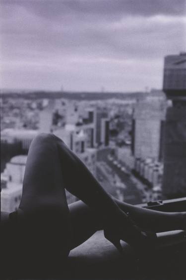 Slim sexy young lady naked on window ledge overlooking Lisbon city in Portugal wearing high heel shoes film photo thumb