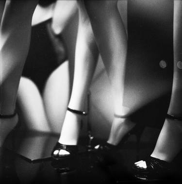 Slim sexy shop dummy mannequin dummy legs in window black and white silver gelatin 35mm analog film photo thumb