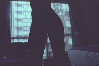 Sexy young lady nude in hotel bedroom in evening light in silhouette 35mm color negative photo in dusk light blue purple thumb