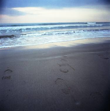 Foot prints at dawn on empty sandy beach sea side Hasselblad square medium format film analogue photograph thumb
